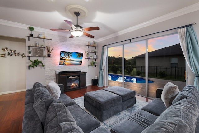 living room with hardwood / wood-style floors, crown molding, and ceiling fan