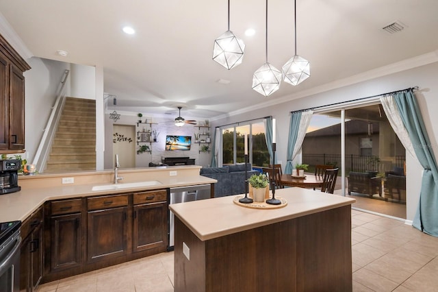 kitchen with a kitchen island, ornamental molding, sink, dark brown cabinetry, and decorative light fixtures