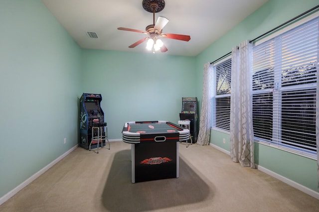 playroom featuring light carpet and ceiling fan