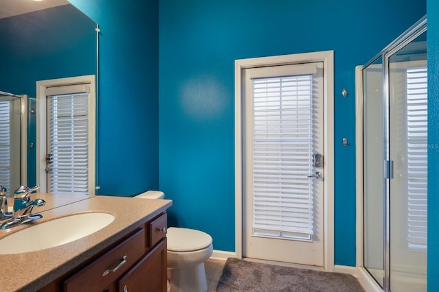 bathroom featuring vanity, tile patterned floors, toilet, and walk in shower