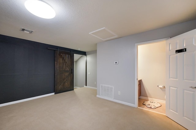 basement with a textured ceiling and light colored carpet