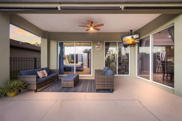 patio terrace at dusk featuring outdoor lounge area and ceiling fan