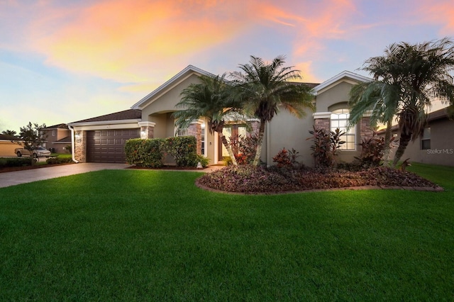 view of front facade featuring a yard and a garage