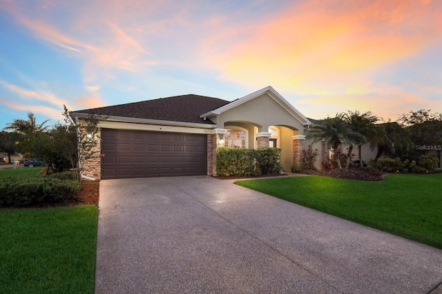 ranch-style house with a garage and a lawn