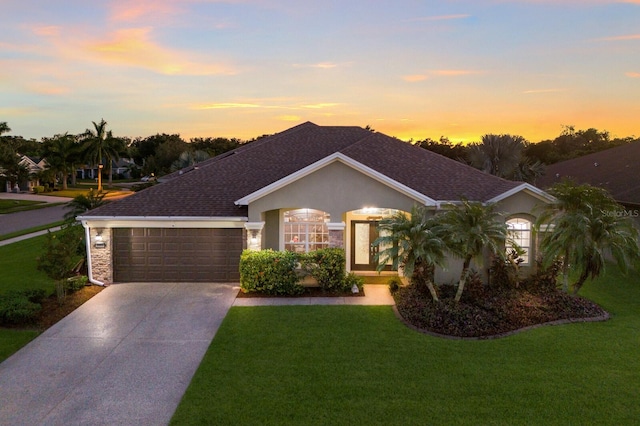 ranch-style house with a yard and a garage