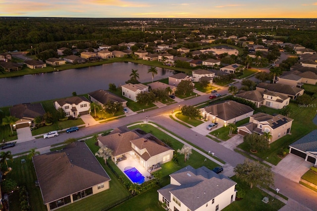 aerial view at dusk with a water view