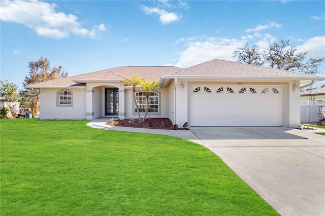 view of front of property featuring a front yard and a garage