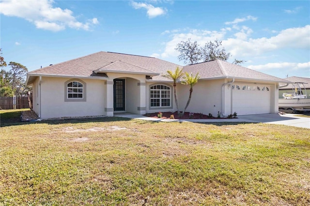 ranch-style house featuring a front lawn and a garage