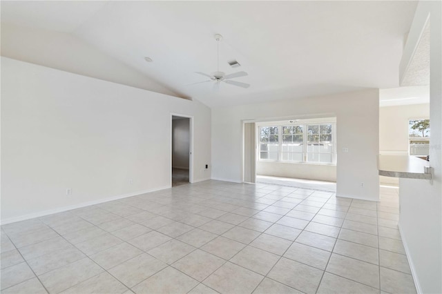 tiled spare room featuring vaulted ceiling and ceiling fan