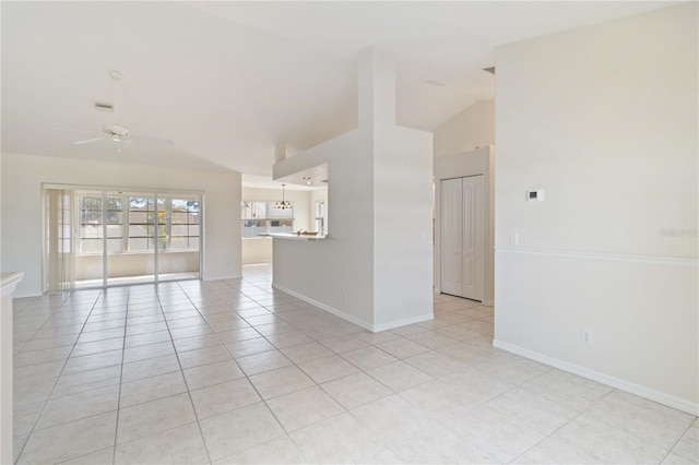 spare room featuring light tile patterned floors, ceiling fan, and lofted ceiling