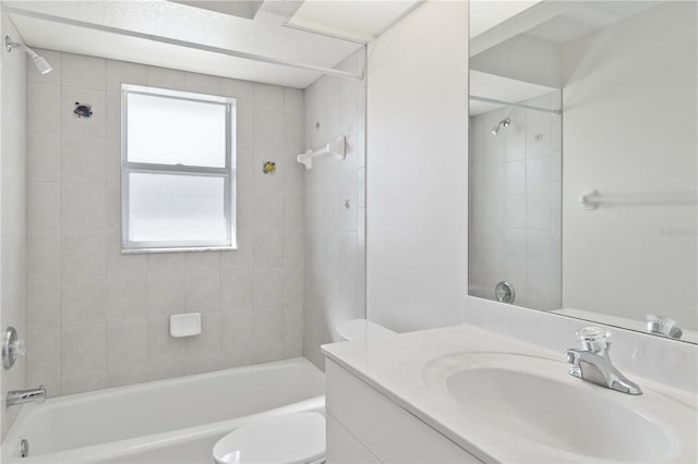 full bathroom featuring toilet, vanity, and tiled shower / bath