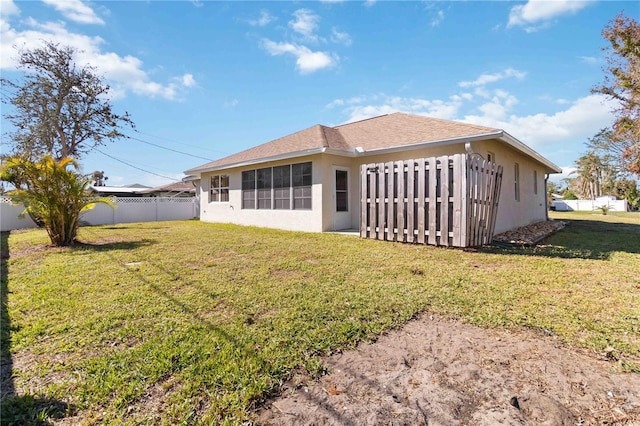 back of property featuring a yard