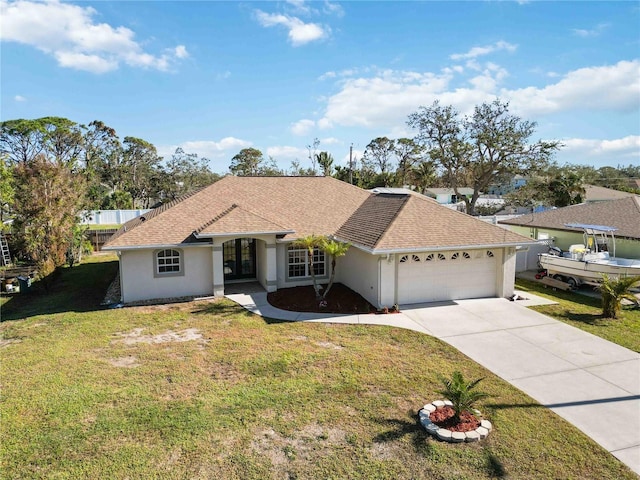 single story home with a garage and a front lawn