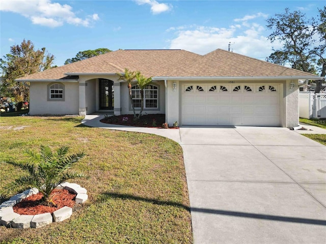 single story home featuring a garage and a front yard