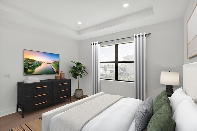 18824 Dayspring Pl, Venice, FL 34293 - bedroom with baseboards, a raised ceiling, recessed lighting, and wood finished floors