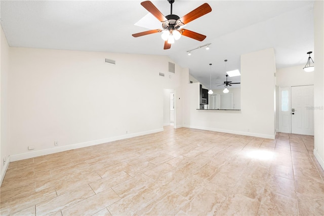 unfurnished living room with ceiling fan, track lighting, and high vaulted ceiling