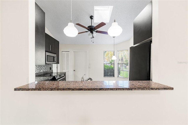 kitchen featuring black range oven, a textured ceiling, pendant lighting, and ceiling fan