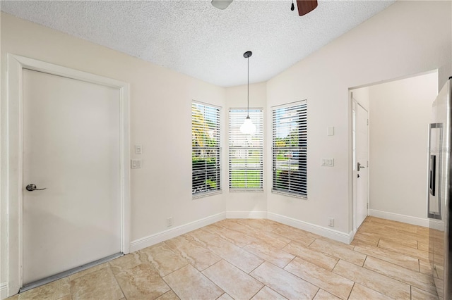 interior space featuring ceiling fan and a textured ceiling