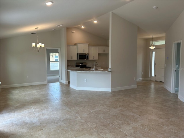 kitchen with stainless steel appliances, decorative light fixtures, sink, and white cabinets