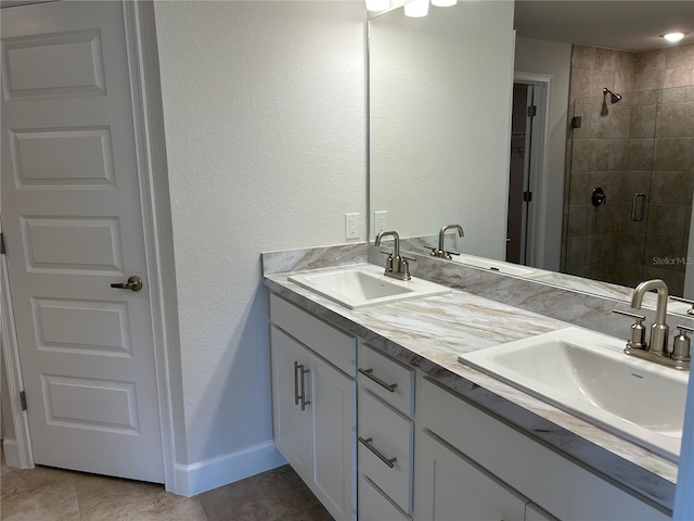 bathroom featuring a shower with door, vanity, and tile patterned flooring