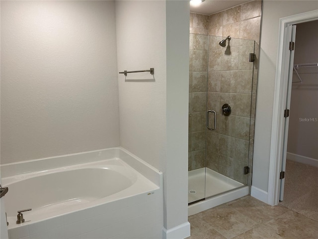 bathroom with tile patterned floors and separate shower and tub