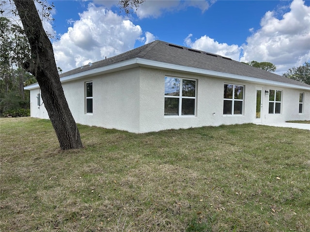 back of property featuring a yard