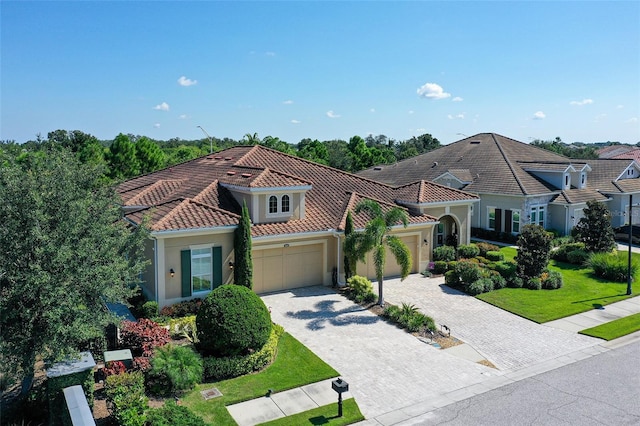 mediterranean / spanish-style house with a front yard