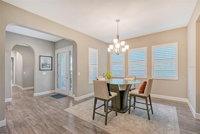 dining room with an inviting chandelier and light hardwood / wood-style flooring