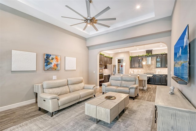 living room featuring light hardwood / wood-style flooring and ceiling fan