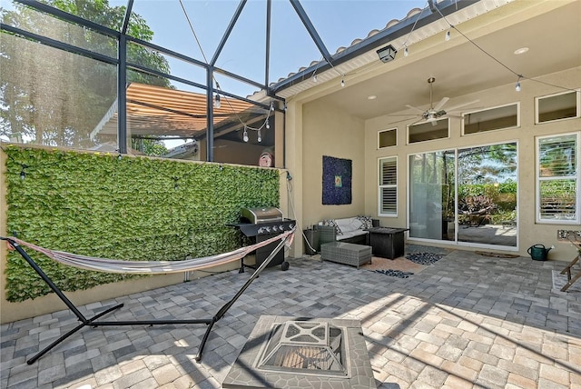 view of patio with glass enclosure, a grill, ceiling fan, and an outdoor hangout area