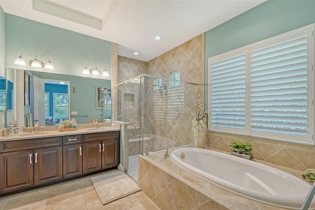 bathroom featuring tile patterned flooring, vanity, and shower with separate bathtub