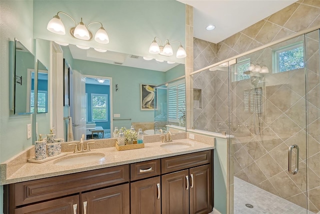 bathroom featuring vanity, walk in shower, and plenty of natural light