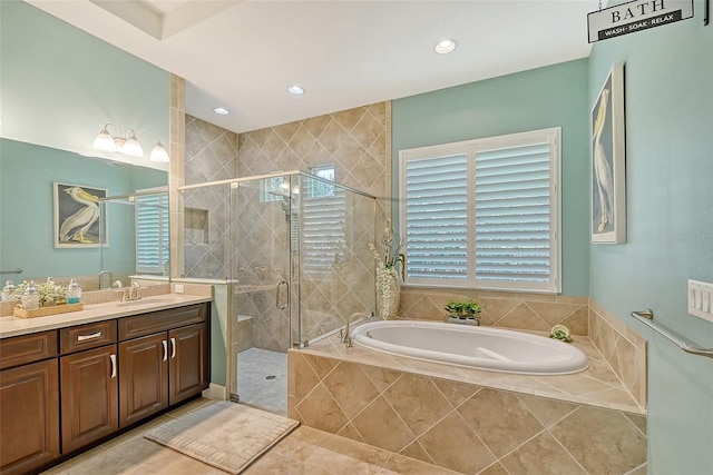 bathroom with tile patterned flooring, vanity, and shower with separate bathtub