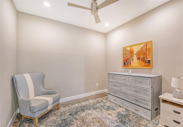 sitting room with hardwood / wood-style flooring and ceiling fan