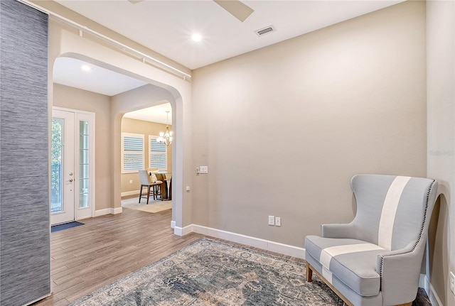 living area featuring a chandelier and hardwood / wood-style flooring