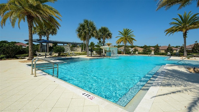 view of swimming pool with a patio area, a pergola, and pool water feature