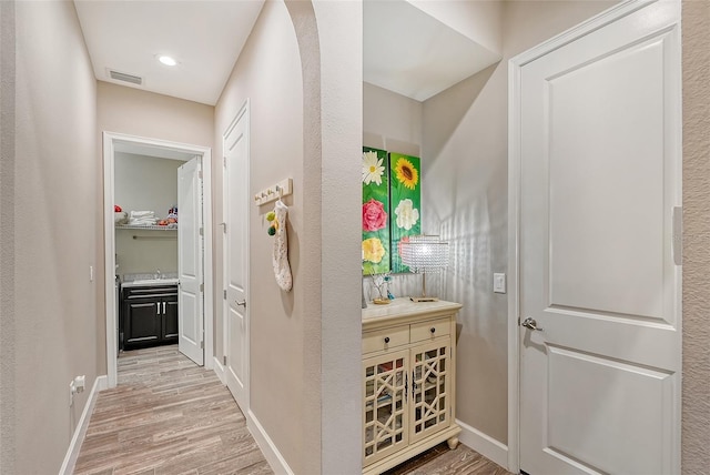 hallway with light wood-type flooring