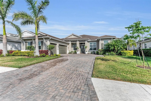 single story home featuring a front lawn and a garage