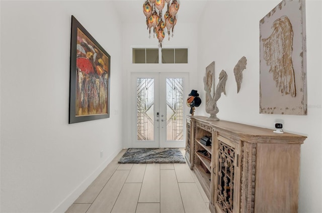 entrance foyer featuring light wood-type flooring and french doors