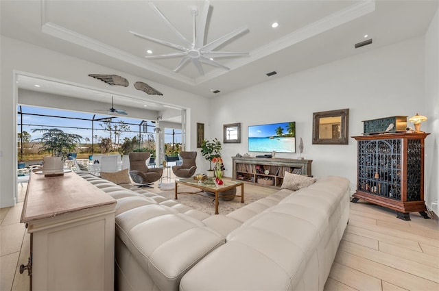 living room featuring ceiling fan, crown molding, and a tray ceiling