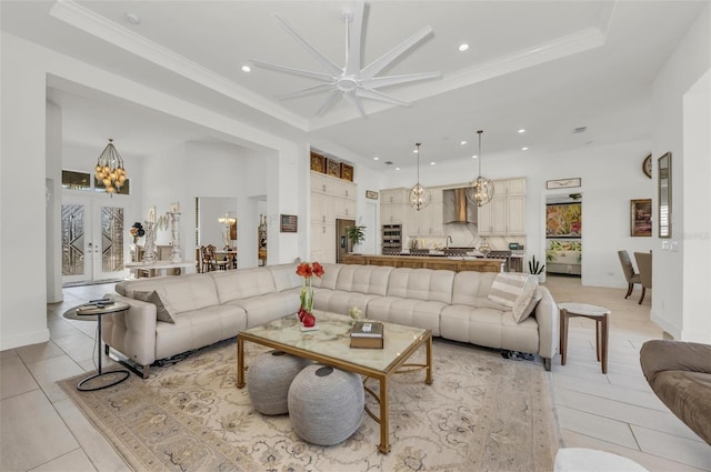 living room featuring ceiling fan, light tile patterned floors, a raised ceiling, and french doors