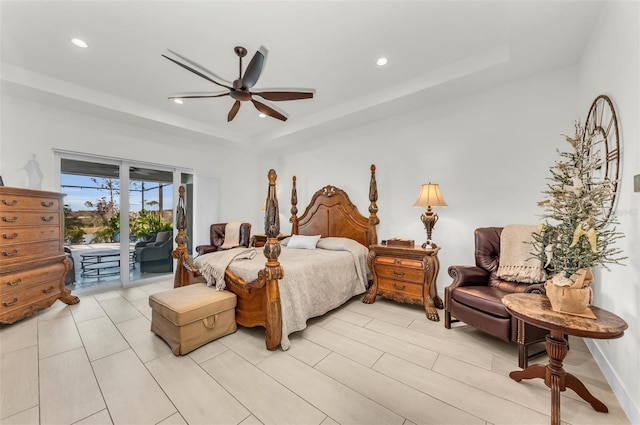 bedroom with access to outside, ceiling fan, and a raised ceiling