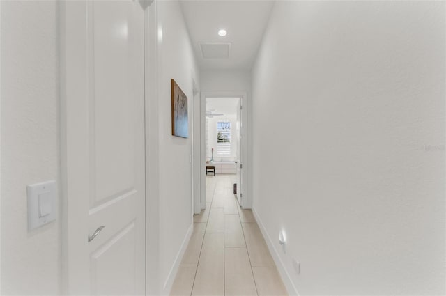 hall featuring light tile patterned floors