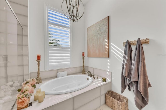 bathroom with independent shower and bath and an inviting chandelier