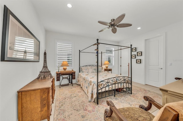 tiled bedroom featuring ceiling fan and multiple windows