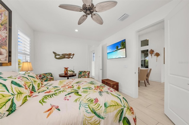 bedroom with ceiling fan and light hardwood / wood-style flooring