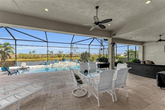 view of patio / terrace featuring ceiling fan, pool water feature, and a lanai