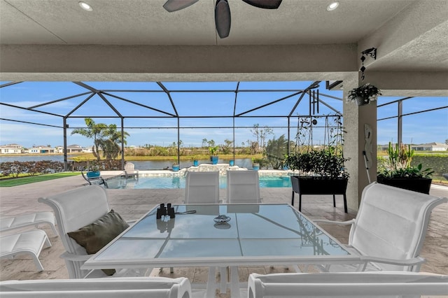 view of patio / terrace featuring a lanai, ceiling fan, and pool water feature