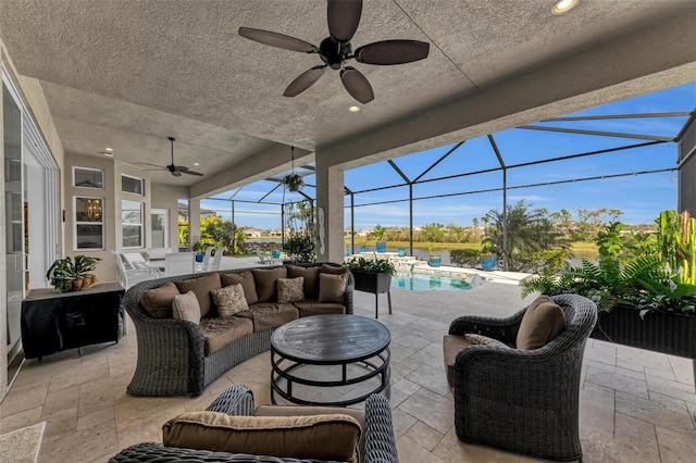 view of patio / terrace with an outdoor living space, glass enclosure, and ceiling fan