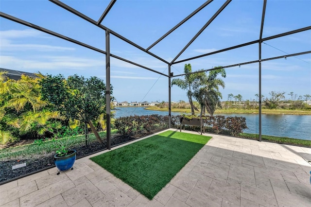 view of patio / terrace featuring glass enclosure and a water view